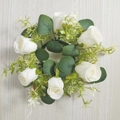 Artificial white rose candle ring with green eucalyptus leaves on a wooden background - White