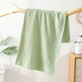 Soft light green coral fleece towel with embossed bear and flower pattern hanging on wood - Green