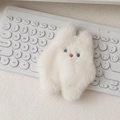 Close-up of white plush bunny coin purse with fine blue and pink embroidery details - White