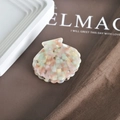 Close-up of shell-shaped acetate hair claw clip with colorful marble pattern and metal spring - 9# Pink Green Marble