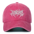 Macro detail of gothic embroidery on pink washed cotton baseball cap fabric - Rose Red