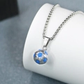 Detailed view of a blue and silver football pendant with a polished silver necklace chain - Box Chain Soccer / Blue