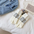 White cotton crew socks with black motivational print in a stylish lifestyle setting - Milk White