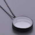 Detailed view of a black round glass locket pendant with a thin metal chain necklace - Inner Diameter 25mm / Black