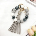 Silicone beaded bracelet keychain with gray tassel and leopard print beads in gold finish - Grey & White Spotted