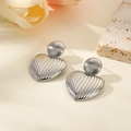 Detailed macro shot of silver heart earrings with vertical striped texture on stone - Silver Style (ZYN-DME513P)