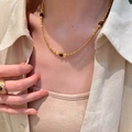 18k gold plated tiger eye beaded necklace for women shown on a model neck - Gold-Coffee (Gold Plated)