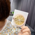 Detailed close-up of a realistic resin lemon slice hair clip on packaging card - Lemon