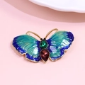 Elegant gold butterfly brooch with blue enamel wings and green gemstone accents - Blue Green Butterfly