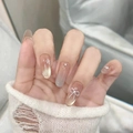 Detailed view of nude gradient almond nails with golden cat-eye effect and pearl bow - Light Ink Bowtie Style (BY1983) / Handmade Nails (Size M/10 Pieces)