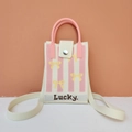 Detailed view of woven phone bag with pink stripes, yellow bow, and a long shoulder strap - Striped Bow (Pink)