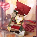 Close-up of 3D Santa Claus character on rustic red and green burlap Christmas stocking - Santa Claus