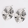 Close-up of silver hollowed leaf earrings with polished stainless steel texture - Steel