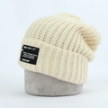 Beige ribbed knit beanie with retro letter patch for a minimalist warm winter style - Off White