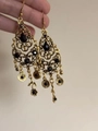 Macro detail of vintage gold bell tassel earrings with intricate hollow carvings and black stones - 58# Ear Hook - Gold