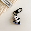 Detail of cute panda surfing keychain with black carabiner on soft knit background - Panda-Skateboard