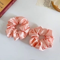 Pair of pink satin scrunchies with floral leopard pattern on a white background - Lotus Pink