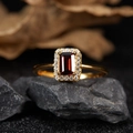 Macro shot of gold S925 ring with garnet stone and white gems on a dark stone background - Natural Garnet Vintage Ring LR378