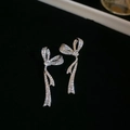 Makro-Detail von silbernen Blättern Quasten-Ohrringen mit Strasssteinen auf schwarzem Grund - Silberne Schleife Zirkonia Quaste (925 Sterling Silver Earring Post)