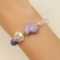 Detail of beaded bracelet with purple shell, crystal stones and pearls on wrist - KC Gold Purple (3623)