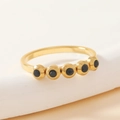 Detail of gold titanium steel ring featuring five bezel-set round black crystals - 17 / Gold/Black Zirconia