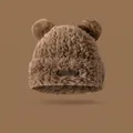 Detail of dark brown plush hat with cute bear ears and a rectangular leather logo patch - Khaki