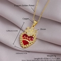 Gold plated copper necklace featuring a red zircon heart crown pendant on silk background - Gold Plated Heart Crown NZ06-3