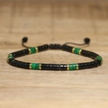 Adjustable woven bracelet with black discs, green translucent stones, and gold metal spacers - No.79 Green Jade & Black Agate