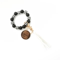 Detail of beaded keychain bracelet with leopard print beads, white tassel and MAMA wood charm - White