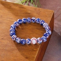Handmade beaded bracelet featuring blue spotted beads and a white baseball charm bead - Blue White Spotted Baseball Bracelet