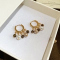 Macro detail of 18k gold plated hoop earrings with tiger eye beads and pearls in a jewelry box - Hoop-Gold-Brown (Tiger Eye)