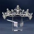 Elegant silver bridal crown with sparkling crystals on a clear display stand - Silver / White Zirconia