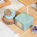 Blue paisley scented candle set in metal tin with matching gift box on bamboo mat - English Pear & Freesia
