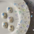 Macro view of transparent nail stickers with abstract colorful jelly blobs and Good Life text - Macaron Irregular Color Blocks (CO-027)