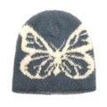 Macro detail of the fuzzy blue knit beanie featuring a large white butterfly jacquard pattern - Gray