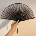 Handheld black ink wash folding fan featuring floral patterns and a dark silk tassel - Ink Apricot Flower