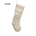 Close-up of small cream knitted Christmas stocking with cable stitch and hanging loop - Small Ivory