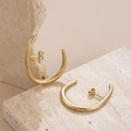 Minimalist gold C-shaped block tassel earrings on a textured stone display - Gold Minimalist Arc Hoop Earrings