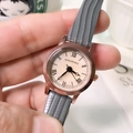 Close-up of Doukou quartz watch with rose gold case, grey leather strap and Roman numerals - Gray