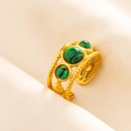 Detail of an adjustable 18K gold ring featuring malachite stones and a twisted band - Gold-Malachite Green