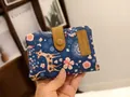 Short tri-fold wallet in navy blue with deer and floral print and snap closure - Handheld Navy Deer Pattern