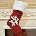 Close-up of red Christmas stocking with plush cuff and snowflake on white fireplace - Snowflake Style