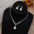 Detailed view of silver bridal jewelry set with pear-cut zircons on a black velvet stand - GS012 Pear Halo Set / Silver