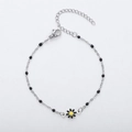 Detail view of silver daisy charm bracelet with black beads and adjustable lobster clasp - Steel + Black