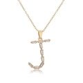 Macro shot of gold 18K plated letter J pendant necklace with baguette zircon stones - Letter J