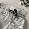 Close-up of black and white checkerboard hair clip on a vintage newspaper background - 9# Large Hair Claw - Five Rings Black