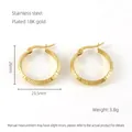 Detail of 18K gold plated stainless steel hoops with Greek meander pattern engraving - Gold