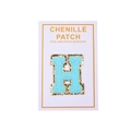 Close-up of light blue chenille letter H patch with gold glitter border and adhesive back - Light Blue Letter H