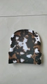 Knitted beanie hat with camo cow pattern in white and dark brown for winter warmth - Irregular Cow Print