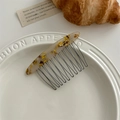 Tortoiseshell acetate hair comb with black metal teeth shown in an aesthetic lifestyle setting - Tortoiseshell Yellow
